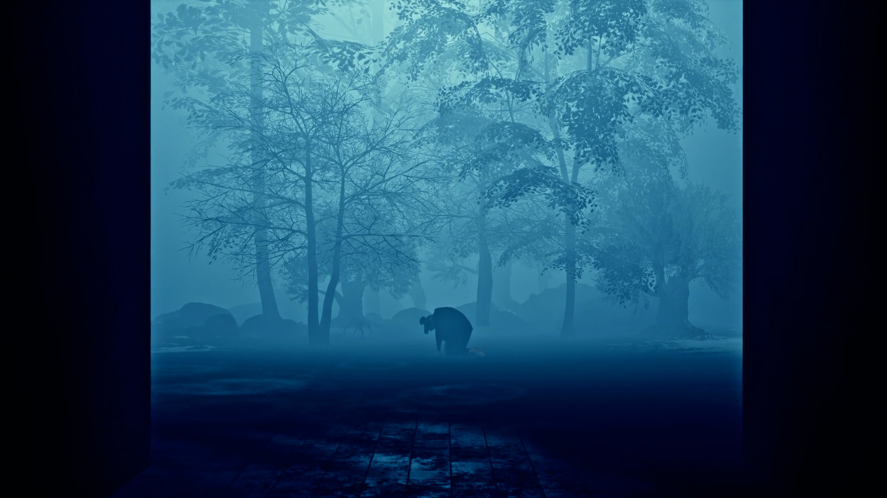 Silhouette of a person kneeling on the ground in a misty forest with dense trees and rocks in dim blue lighting.