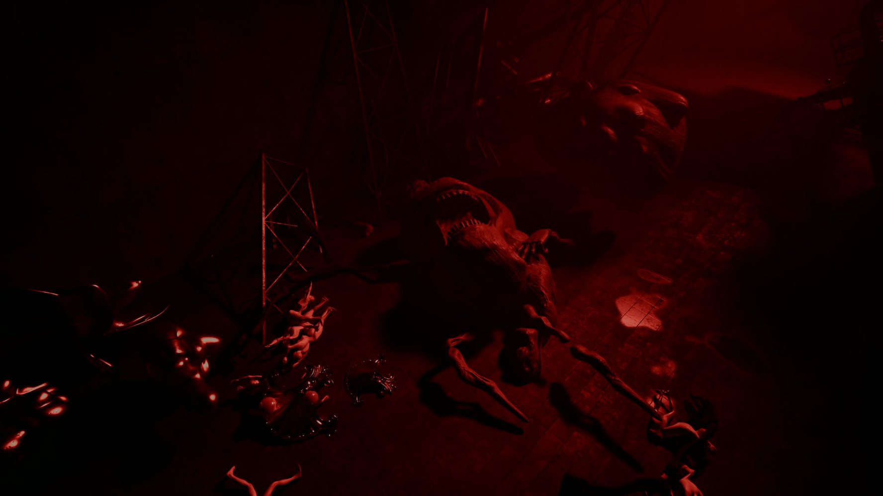 Dark scene bathed in red light featuring a large, monstrous creature lying on the ground surrounded by scattered limbs and human figures in distress.